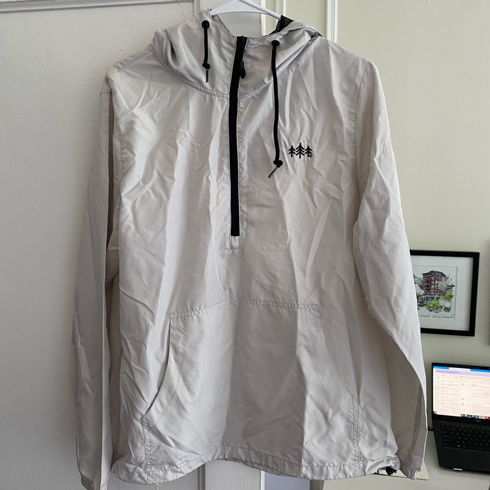 A lightweight, white quarter-zip windbreaker from TriPine clothing.